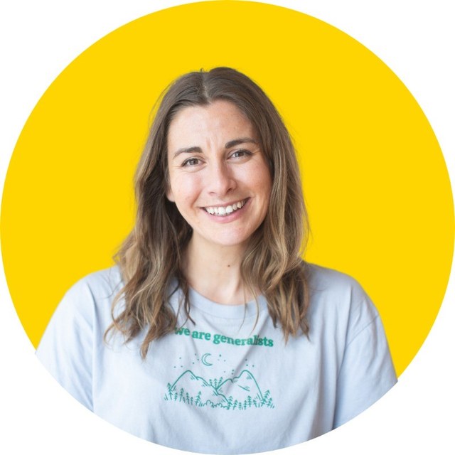 Milly Tamati, smiling, in a we are generalists T-shirt against a yellow background