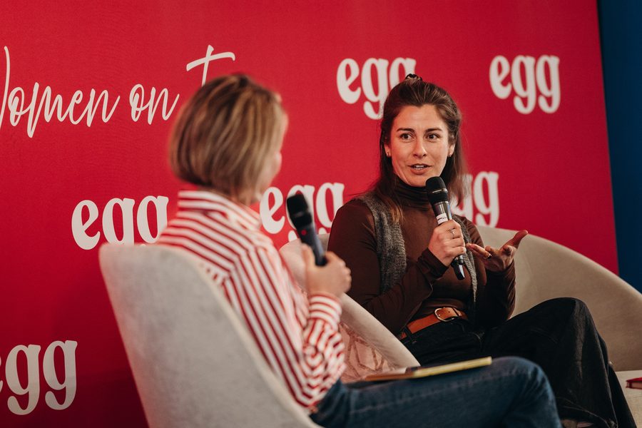 Milly on a panel with a microphone at the egg Women on Top event