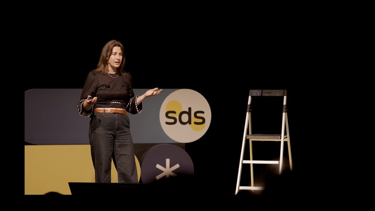 Milly Tamati speaking on stage at The Slowdown Summit